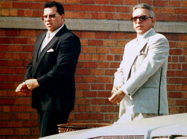 Charlie Carneglia (right) walking with John Gotti Jr., outside a funeral home.